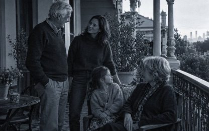 Three generations of a family on a verandah at home